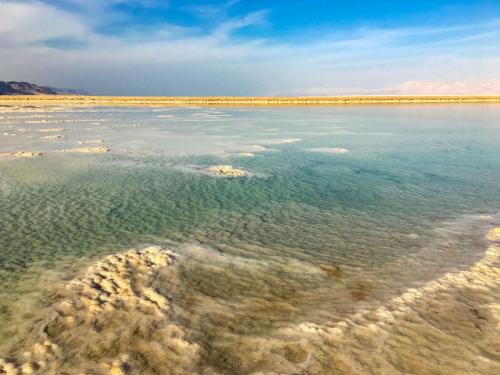 Hellblau schimmernden Wassernot Salzablagerungen im Toten Meer in Israel